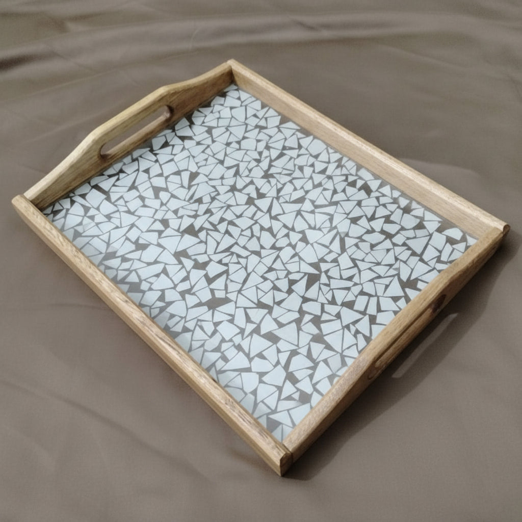 Wooden tray with a mosaic glass top on a beige surface
